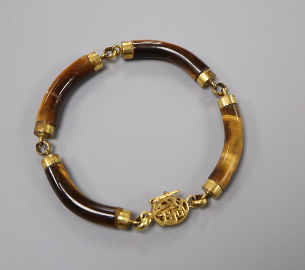 A Chinese 14k and tigers eye quartz link bracelet (one link cracked and glued), gross 22.4 grams.